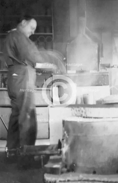 Mr. Kah smelting gold at the Assay Office, between c1900 and 1916. Creator: Unknown.