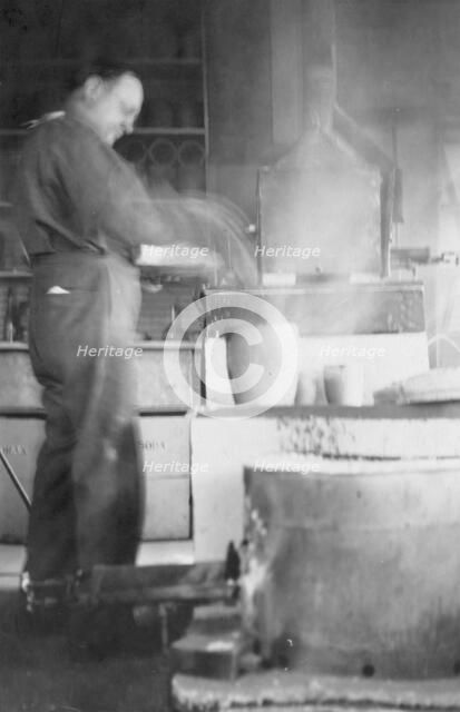 Mr. Kah smelting gold at the Assay Office, between c1900 and 1916. Creator: Unknown.