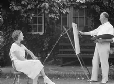Mr. Hamilton King painting Mrs. Hamilton's portrait outdoors, between 1934 and 1942. Creator: Arnold Genthe
