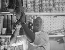 Mr. J. Benjamin, a store owner, Washington, D.C., 1942. Creator: Gordon Parks