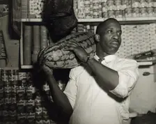 Mr. J. Benjamin, owner of the grocery store patronized by Mrs. Ella Watson..., Washington, DC, 1942. Creator: Gordon Parks