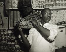 Mr. J. Benjamin, owner of the grocery store patronized by Mrs. Ella Watson..., Washington, DC, 1942. Creator: Gordon Parks
