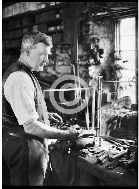 Mr Jefferies at work in the forge, Southrop, Cotswolds, Gloucestershire, 1938. Creator: Sydney Alfred Pitcher.