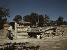 Mr. Leatherman, homesteader, coming out of his dugout home, Pie Town, New Mexico, 1940. Creator: Russell Lee