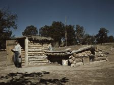 Mr. Leatherman, homesteader, coming out of his dugout home, Pie Town, New Mexico, 1940. Creator: Russell Lee