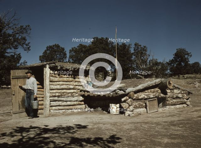 Mr. Leatherman, homesteader, coming out of his dugout home, Pie Town, New Mexico, 1940. Creator: Russell Lee.
