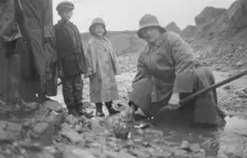 Mr. Lindeberg panning gold at Pioneer Mine with a shovel, between c1900 and 1916. Creator: Unknown