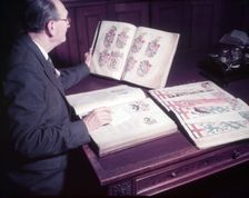 Mr. Mitchell (Herald Painter) in Records Room, College of Arms, London, c1953. Creator: Arthur Charles Kirby Ware