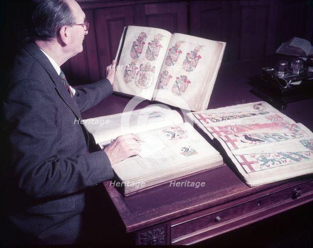 Mr. Mitchell (Herald Painter) in Records Room, College of Arms, London, c1953. Creator: Arthur Charles Kirby Ware.