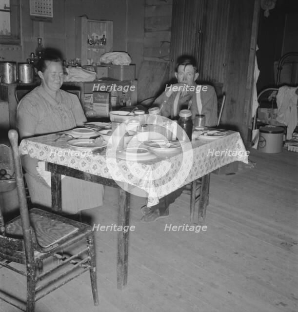 Mr. Wardlow says grace before dinner, Dead Ox Flat, Malheur County, Oregon, 1939. Creator: Dorothea Lange.