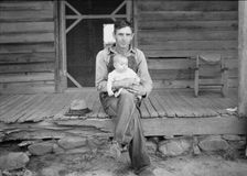 Mr. Whitfield, tobacco sharecropper with baby..., North Carolina, Person County, 1939. Creator: Dorothea Lange