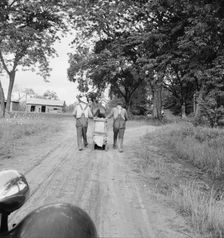 Mr. Taylor and wage laborer slide tobacco to the barn..., Granville County, North Carolina, 1939. Creator: Dorothea Lange