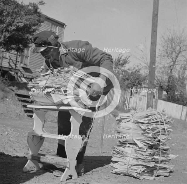 Mr. Venus Alsobrook, official salvage collector for the government wrapping..., Washington, DC, 1942 Creator: Gordon Parks.