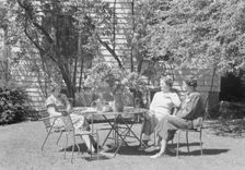 Mrs. Mary Benson and two identified women seated outdoors at a table, between 1933 and 1942. Creator: Arnold Genthe