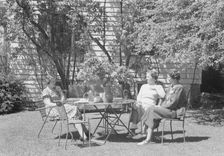 Mrs. Mary Benson and two identified women seated outdoors at a table, between 1933 and 1942. Creator: Arnold Genthe