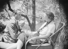 Mrs. Mary Benson and unidentified man, seated outdoors, 1933. Creator: Arnold Genthe