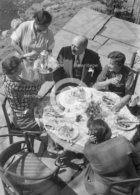 Mrs. Mary Benson and other people seated outdoors, 1933. Creator: Arnold Genthe.