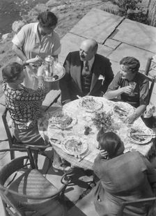 Mrs. Mary Benson and other people seated outdoors, 1933. Creator: Arnold Genthe