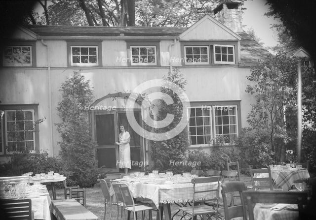 Mrs. Mary Benson standing at the entrance to her house, between 1933 and 1942. Creator: Arnold Genthe.