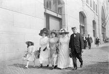 Mrs. Mills, Mrs. Hyde, Mrs. Ginnett, a detective and a little girl walking down the street..., 1910. Creator: Bain News Service