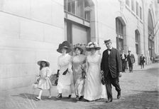 Mrs. Mills, Mrs. Hyde, Mrs. Ginnett, a detective and a little girl walking down the street..., 1910. Creator: Bain News Service