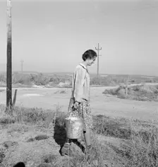 Mrs. Bartheloma hauls water from irrigation ditch, Nyssa Heights, Malheur County, Oregon, 1939. Creator: Dorothea Lange