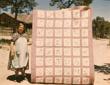 Mrs. Bill Stagg with state quilt that she made, Pie Town, New Mexico. , 1940. Creator: Russell Lee