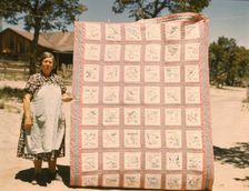 Mrs. Bill Stagg with state quilt that she made, Pie Town, New Mexico. , 1940. Creator: Russell Lee