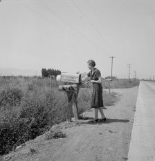 Mrs. Bouchey gets the morning mail, Washington, Yakima Valley, near Toppenish, 1939. Creator: Dorothea Lange