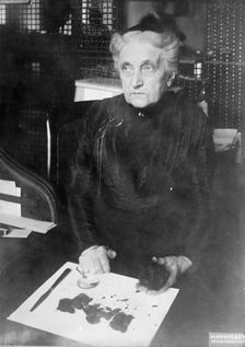 Mrs. Brown of Treasury Department - Identifying Damaged Bills For Redemption, 1913. Creator: Harris & Ewing
