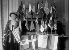Mrs. Carrie Chapman Catt with Flags of 22 Nations, 1917. Creator: Harris & Ewing