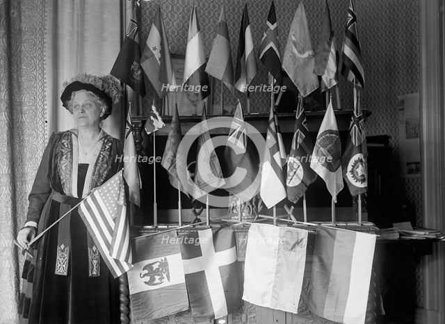 Mrs. Carrie Chapman Catt with Flags of 22 Nations, 1917. Creator: Harris & Ewing.