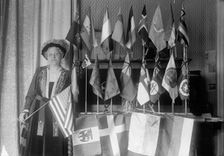 Mrs. Carrie Chapman Catt with Flags of 22 Nations, 1917. Creator: Harris & Ewing
