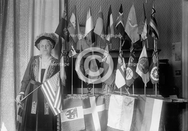 Mrs. Carrie Chapman Catt with Flags of 22 Nations, 1917. Creator: Harris & Ewing.