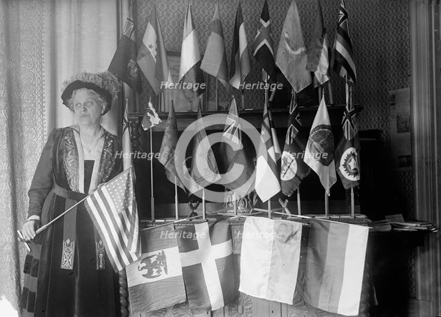 Mrs. Carrie Chapman Catt with Flags of 22 Nations, 1917. Creator: Harris & Ewing.