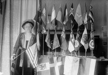 Mrs. Carrie Chapman Catt with Flags of 22 Nations, 1917. Creator: Harris & Ewing