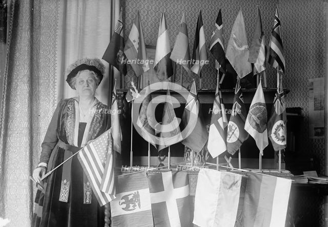 Mrs. Carrie Chapman Catt with Flags of 22 Nations, 1917. Creator: Harris & Ewing.