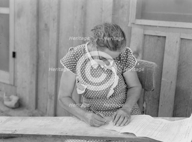 Mrs. Cates signs chattel mortgage with "X", Malheur County, Oregon, 1939. Creator: Dorothea Lange.