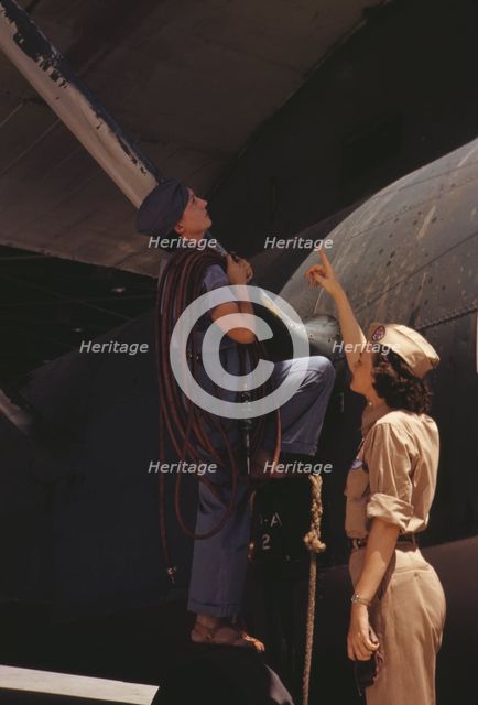 Mrs. Cora Ann Bowen (left) works as a cowler at the Naval Air Base..., Corpus Christi, Texas, 1942. Creator: Howard Hollem.