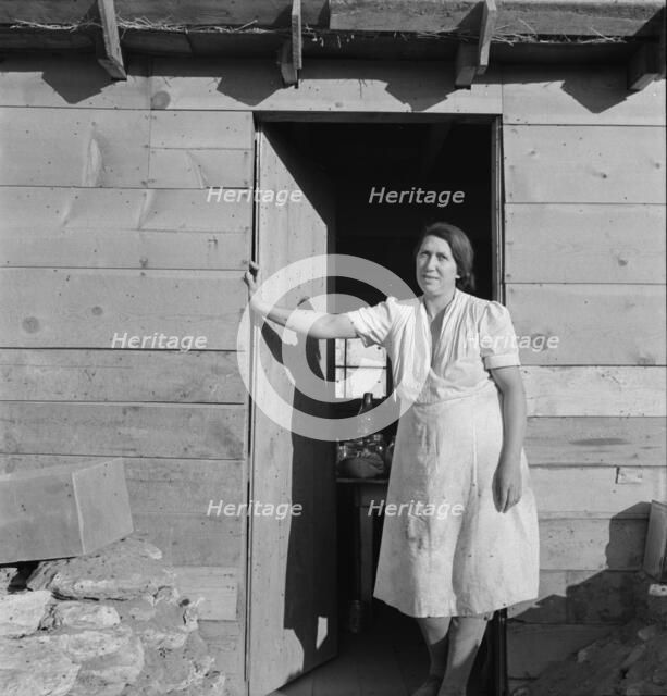 Mrs. Dougherty in doorway of basement house, Warm Springs, Malheur County, Oregon, 1939. Creator: Dorothea Lange.