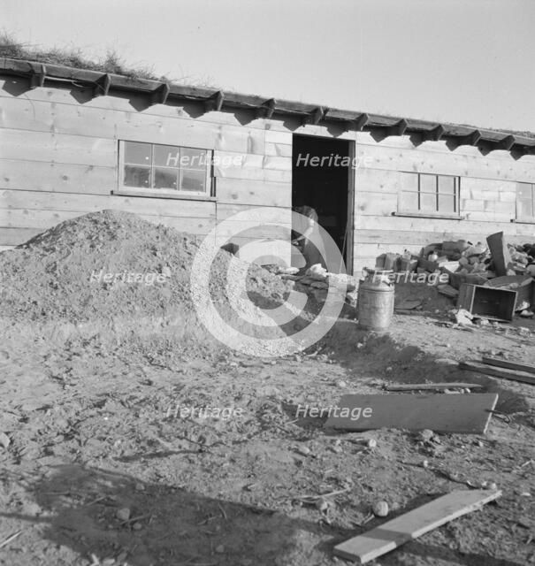 Mrs. Dougherty in doorway of basement house, Warm Springs, Malheur County, Oregon, 1939. Creator: Dorothea Lange.