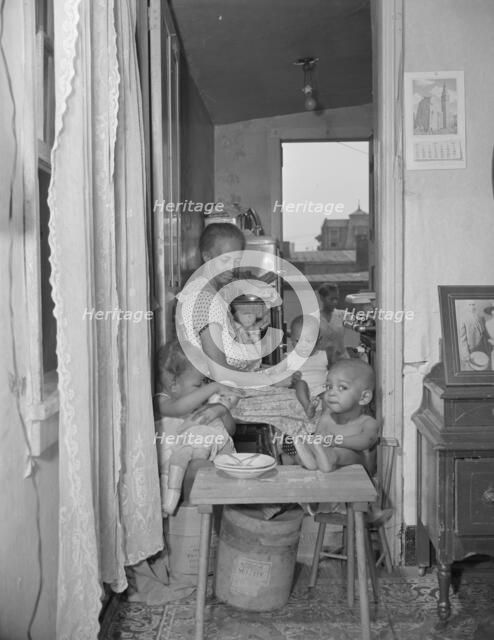Mrs. Ella Watson, a government charwoman and her grandchildren, Washington, D.C., 1942. Creator: Gordon Parks.