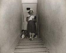 Mrs. Ella Watson, a government charwoman, leaves for work at 4:30 p.m., Washington, D.C., 1942. Creator: Gordon Parks