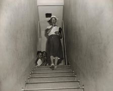 Mrs. Ella Watson, a government charwoman, leaves for work at 4:30 p.m., Washington, D.C., 1942. Creator: Gordon Parks