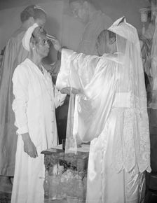 Mrs. Ella Watson, a government charwoman, receiving annointment..., Washington, D.C., 1942. Creator: Gordon Parks