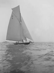 Mrs GA Shenley at the helm of the 8 Metre class sailing yacht Spero (H8). Creator: Kirk & Sons of Cowes