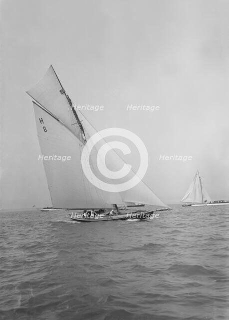 Mrs GA Shenley at the helm of the 8 Metre class 'Spero' (H8). Creator: Kirk & Sons of Cowes.