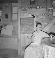 Mrs. Hull in one-room dugout basement home, Dead Ox Flat, Malheur County, Oregon, 1939. Creator: Dorothea Lange
