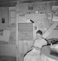 Mrs. Hull in one-room dugout basement home, Dead Ox Flat, Malheur County, Oregon, 1939. Creator: Dorothea Lange