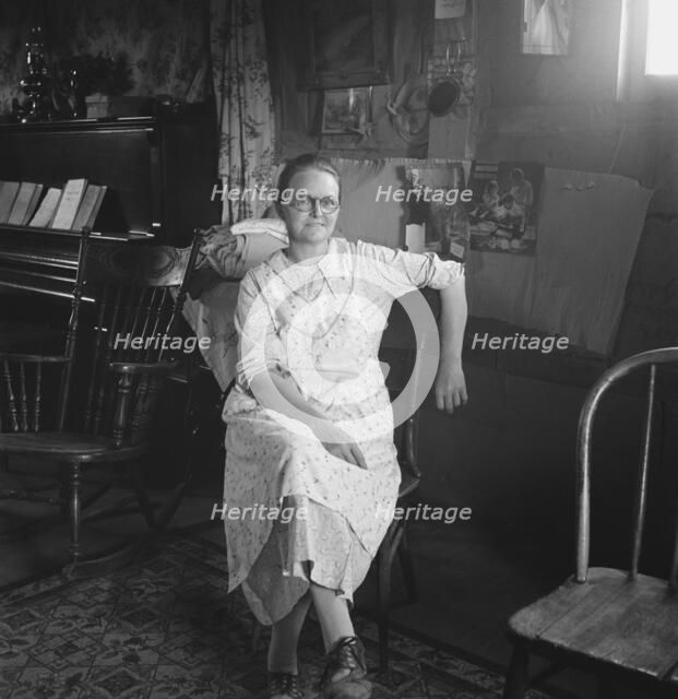 Mrs. Hull in one-room dugout basement home, Dead Ox Flat, Malheur County, Oregon, 1939. Creator: Dorothea Lange.